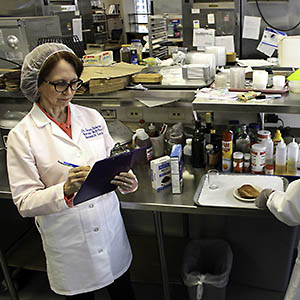 Two people prepare food for study participants