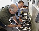 Scientists installing camera equipment inside airplane