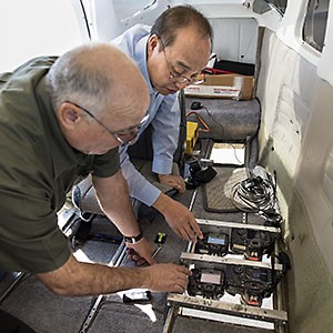 Scientists installing camera equipment inside airplane