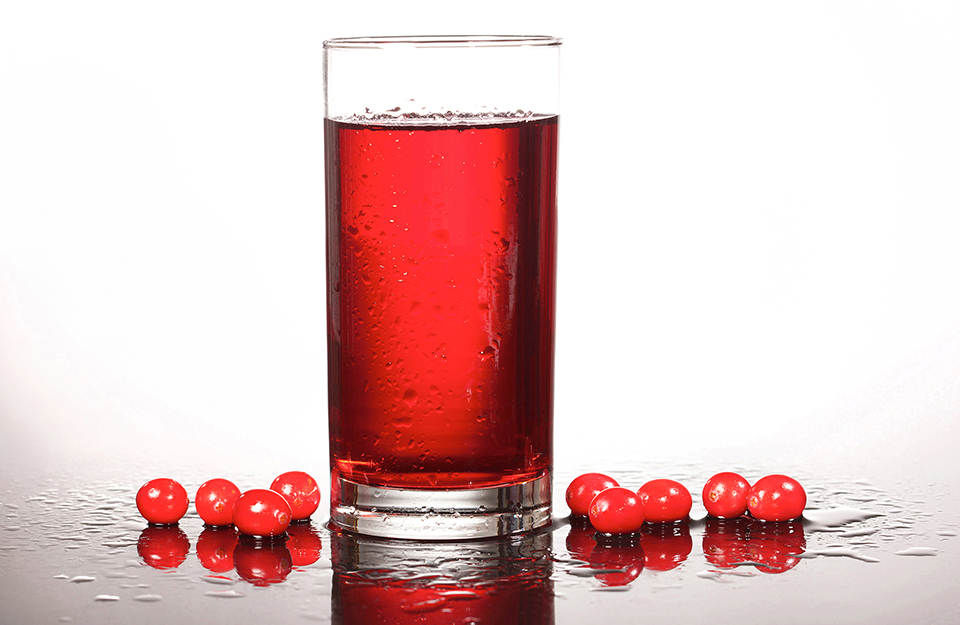A glass of cranberry juice and cranberries