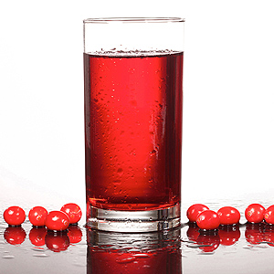 A glass of cranberry juice and cranberries