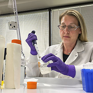 ARS scientist prepares disinfecting solutions